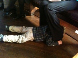 Hiding between my legs, under a pew